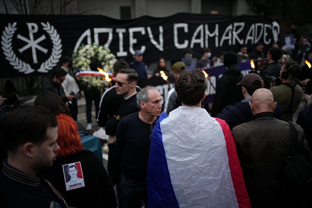 People hold a banner reading 'Goodbye comrade' as they take part in a march in Lyon, France, Saturday, Feb. 21, 2026, to pay tribute to Quentin Deranque, a 23-year-old nationalist activist who died from a beating after a clash between far-left and far-right supporters. (AP Photo/Laurent Cipriani)