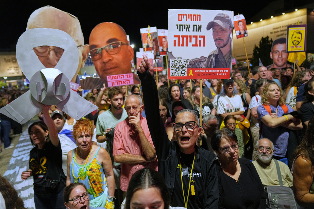 People take part in a rally demanding the returning of the bodies of hostages kidnapped by Hamas who are still in Gaza Strip, at a plaza known as hostages square, in Tel Aviv, Israel, Saturday, Oct. 18, 2025. (AP Photo/Francisco Seco)