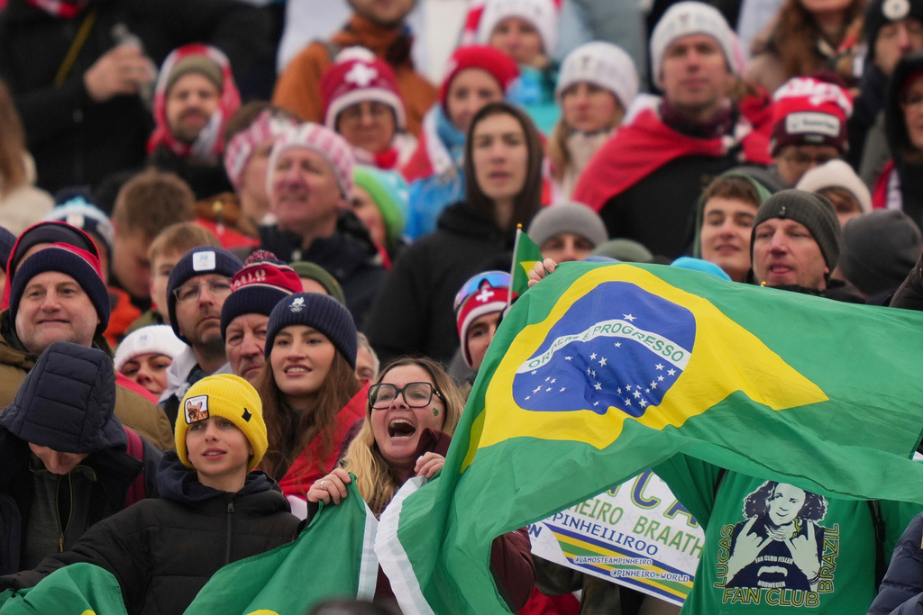 Brazilian fans cheer during the medal ceremony of an alpine ski, men's giant slalom race, won by Brazil's Lucas Pinheiro Braathen, at the 2026 Winter Olympics, in Bormio, Italy, Saturday, Feb. 14, 2026. (AP Photo/Julia Demaree Nikhinson)