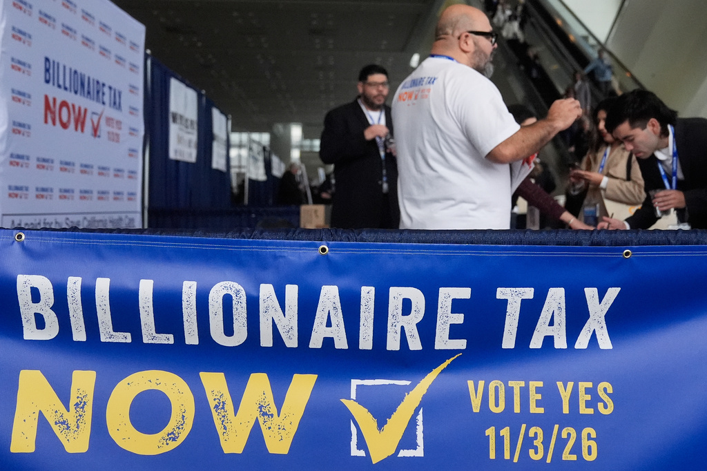 FILE - People visit the Billionaire Tax Now booth at the 2026 California Democratic Party State Convention in San Francisco, Feb. 21, 2026. (AP Photo/Jeff Chiu, File)