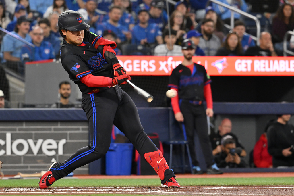 Toronto Blue Jays' Kazuma Okamoto hits an RBI double against the Cincinnati Reds, scoring Alejandro Kirk, during the first inning of a baseball game in Toronto, Friday, Sept. 25, 2026. (Jon Blacker/The Canadian Press via AP)