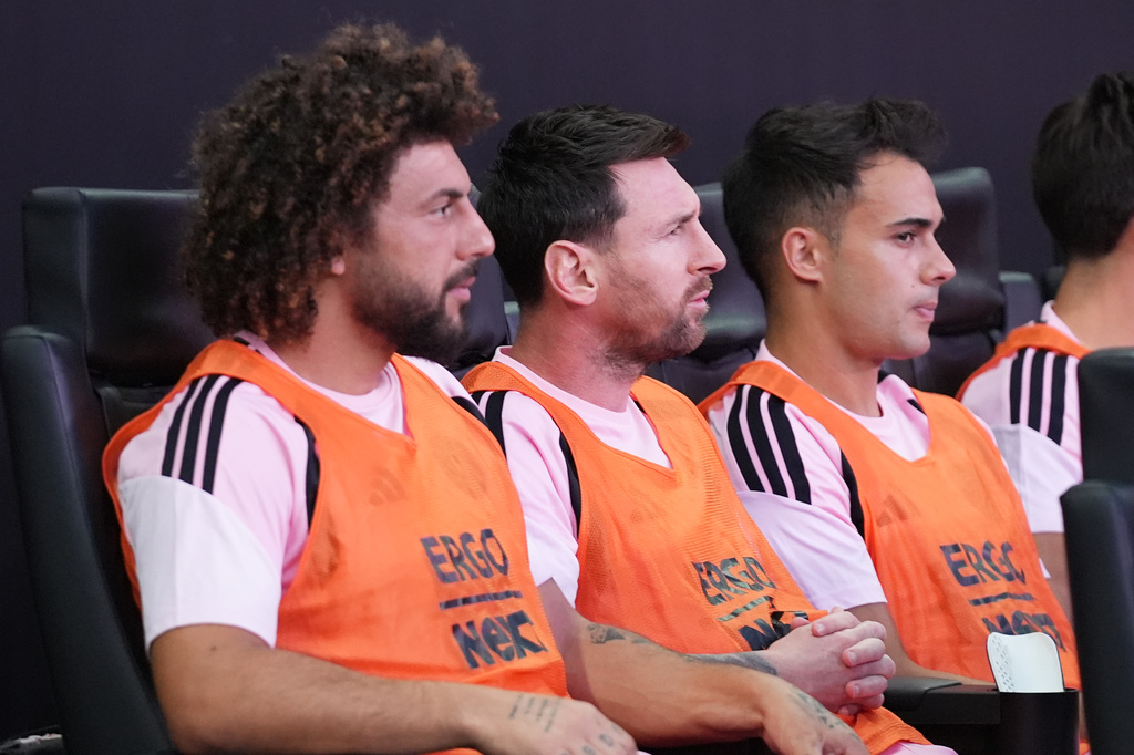 Inter Miami forward Leo Messi, center, sits on the bench before a Leagues Cup soccer match against Club León, Wednesday, Aug. 12, 2026, in Miami. (AP Photo/Lynne Sladky)
