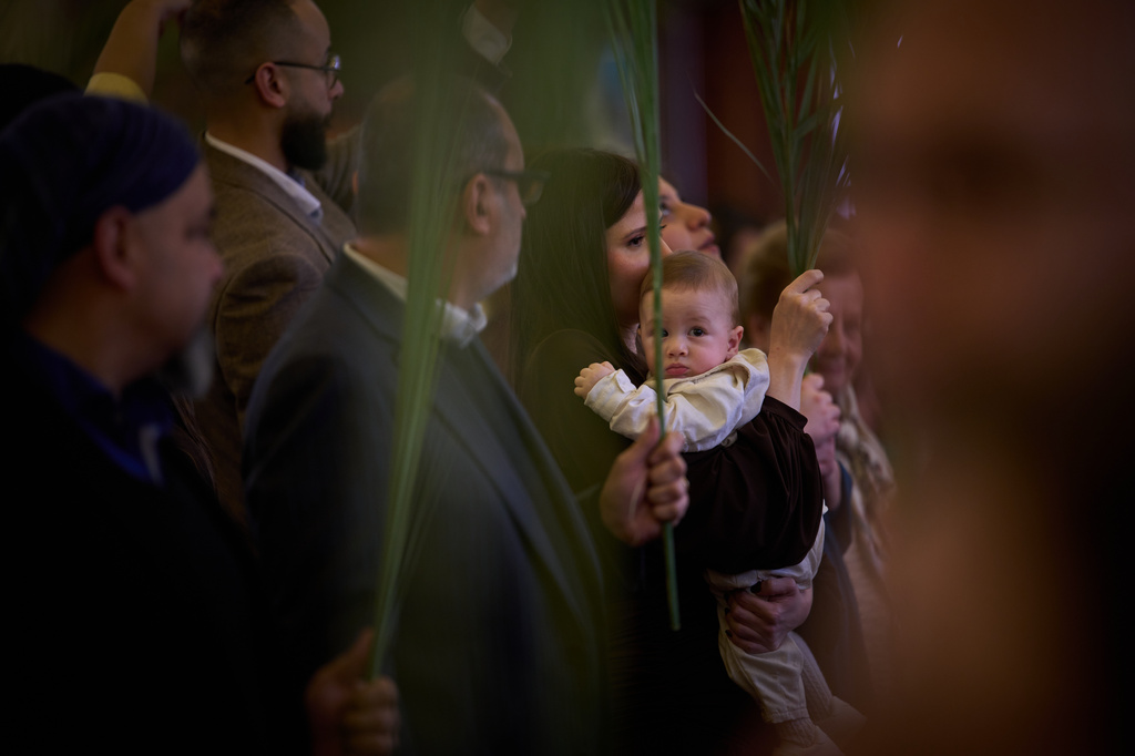 Parishioners hold palm branches during the Palm Sunday celebration at the Our Lady of Hadat Church in Beirut, Lebanon, Sunday, March 29, 2026. (AP Photo/Emilio Morenatti)