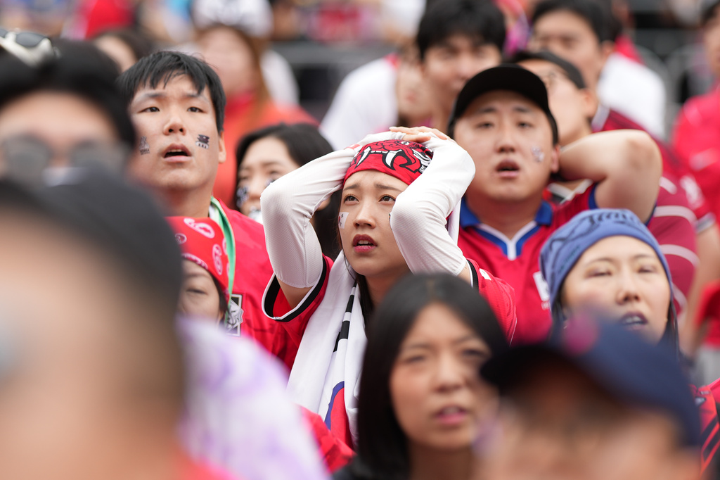 Soccer fans react as they watch a live broadcasting of the World Cup Group A soccer match between South Africa and South Korea at a public viewing venue in Seoul, South Korea, Thursday, June 25, 2026. (AP Photo/Lee Jin-man)