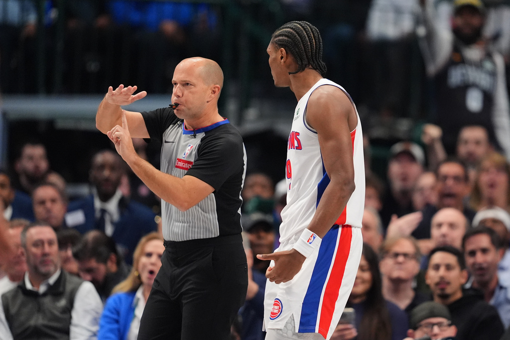 Referee John Goble (10) issues a technical foul to Detroit Pistons' Ausar Thompson, right, in the first half of an NBA basketball game against the Dallas Mavericks in Dallas, Thursday, Dec. 18, 2025. (AP Photo/Tony Gutierrez)