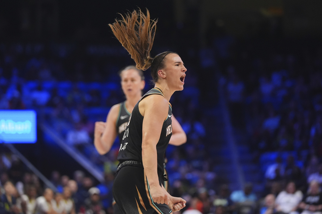 New York Liberty guard Sabrina Ionescu (20) reacts to scoring a basket during the second half of a WNBA basketball game against the Dallas Wings in Arlington, Texas, Friday, Aug. 8, 2025. (AP Photo/LM Otero)