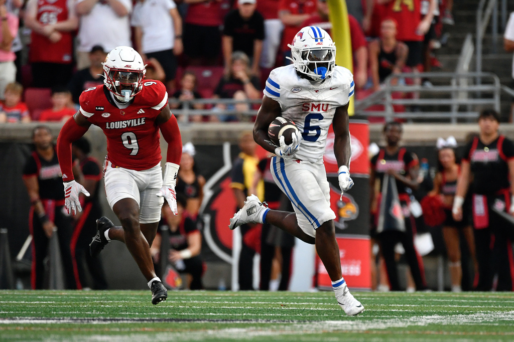 SMU running back Kendrick Raphael (6) runs from the pursuit from Louisville defensive back Antonio Watts (9) during the second half of an NCAA college football game in Louisville, Ky., Saturday, Sept. 19, 2026. (AP Photo/Timothy D. Easley)