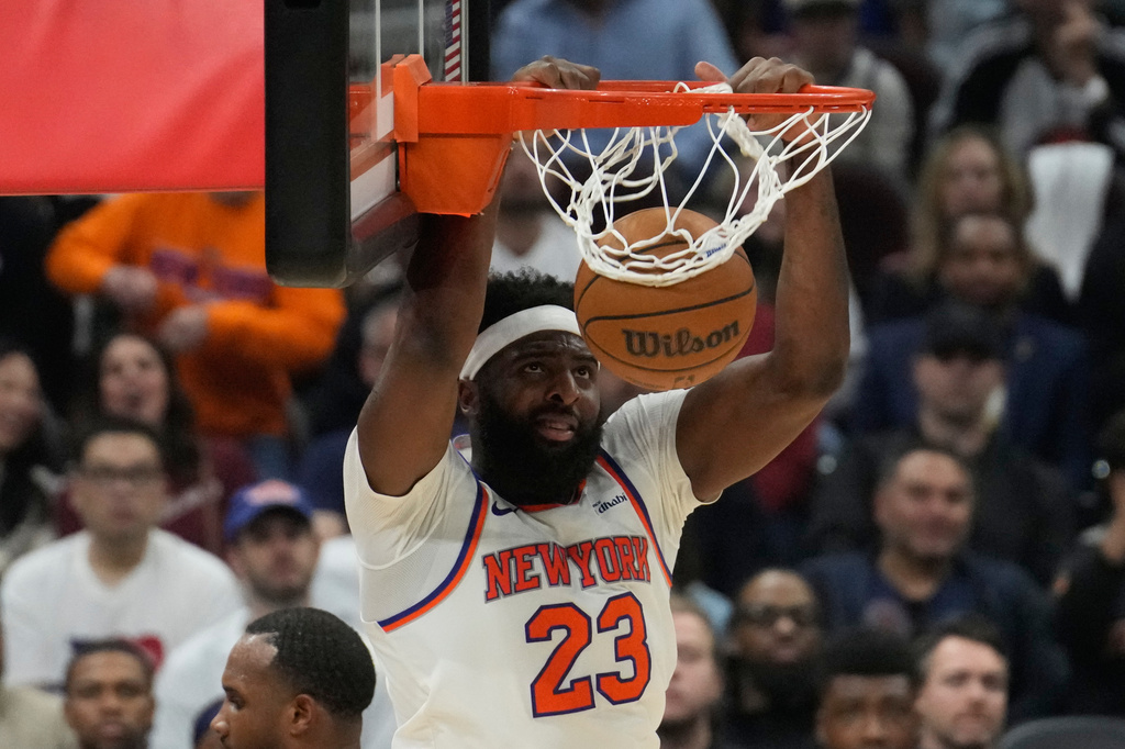 New York Knicks center Mitchell Robinson dunks during the second half of Game 4 in the Eastern Conference finals NBA basketball playoffs series against the Cleveland Cavaliers in Cleveland, Monday, May 25, 2026. (AP Photo/Sue Ogrocki)