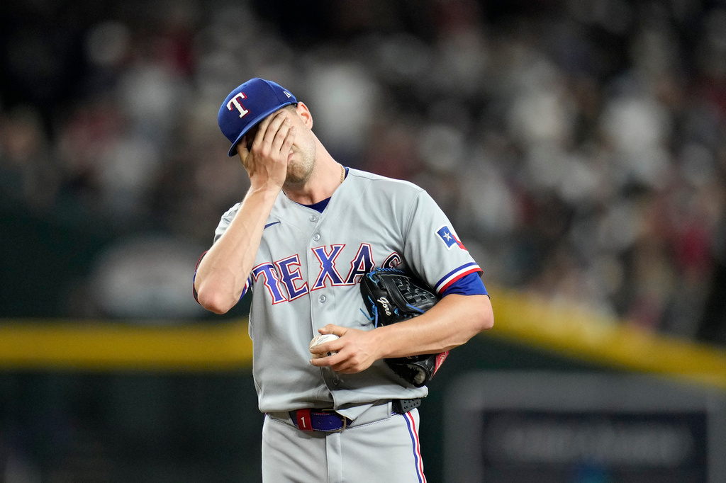 Texas Rangers starting pitcher MacKenzie Gore pauses at the pitcher's mound after giving up a two-run double to Arizona Diamondbacks' Ketel Marte during the fifth inning of a baseball game, Friday, Sept. 11, 2026, in Phoenix. (AP Photo/Ross D. Franklin)