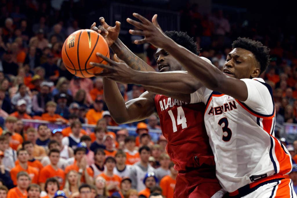 Alabama center Charles Bediako (14) and Auburn forward Keshawn Murphy (3) battle for a rebound during the first half of an NCAA college basketball game Saturday, Feb. 7, 2026, in Auburn, Ala. (AP Photo/Butch Dill)