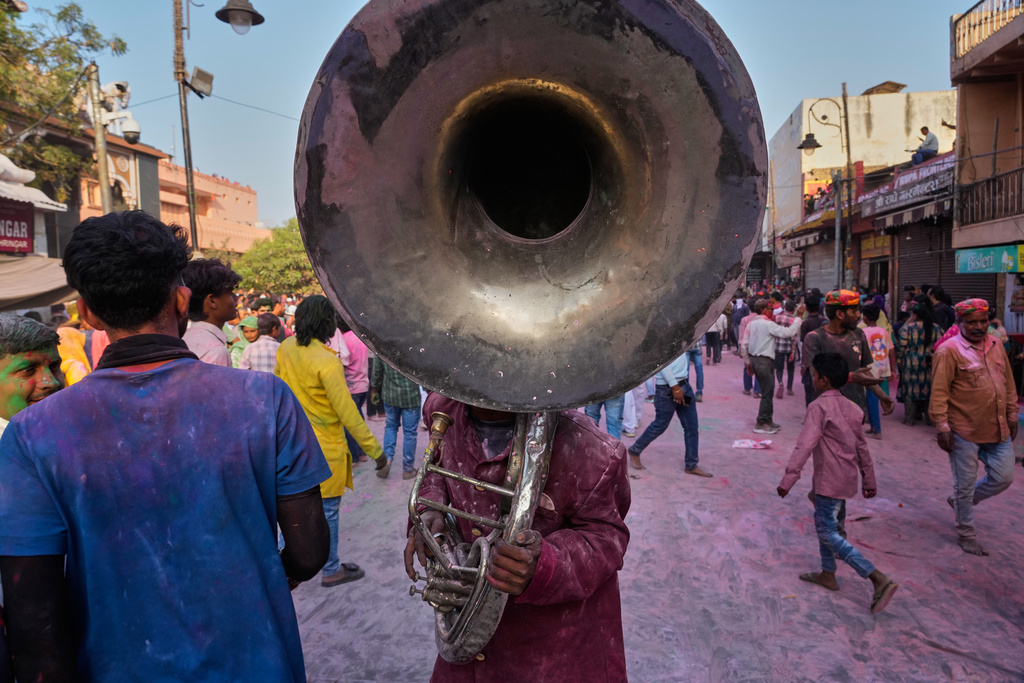 A member of a band accompanying a Holi festival procession plays a brass instrument in Mathura, India, on Feb. 27, 2026. (AP Photo/Manish Swarup)