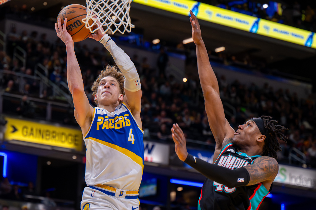 Indiana Pacers guard Taelon Peter (4) goes up to dunk during the second half of an NBA basketball game against the Memphis Grizzlies in Indianapolis, Sunday, March 1, 2026. (AP Photo/Doug McSchooler)