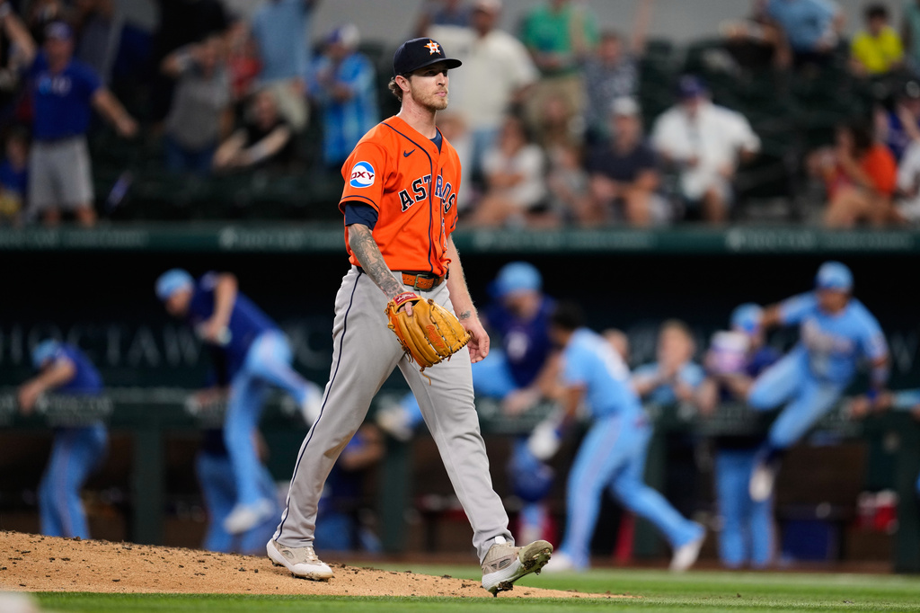 Houston Astros pitcher Josh Hader walks to the dugout after giving up a run-scoring single to Texas Rangers' Brandon Nimmo in the ninth inning of a baseball game in Arlington, Texas, Sunday, July 12, 2026. (AP Photo/Tony Gutierrez)