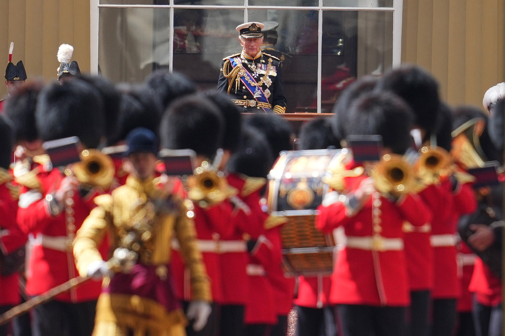 Britain's King Charles III oversees members of the Guards marching after the State Opening of Parliament at Buckingham Palace in London, Wednesday, May 13, 2026. (AP Photo/Kin Cheung)