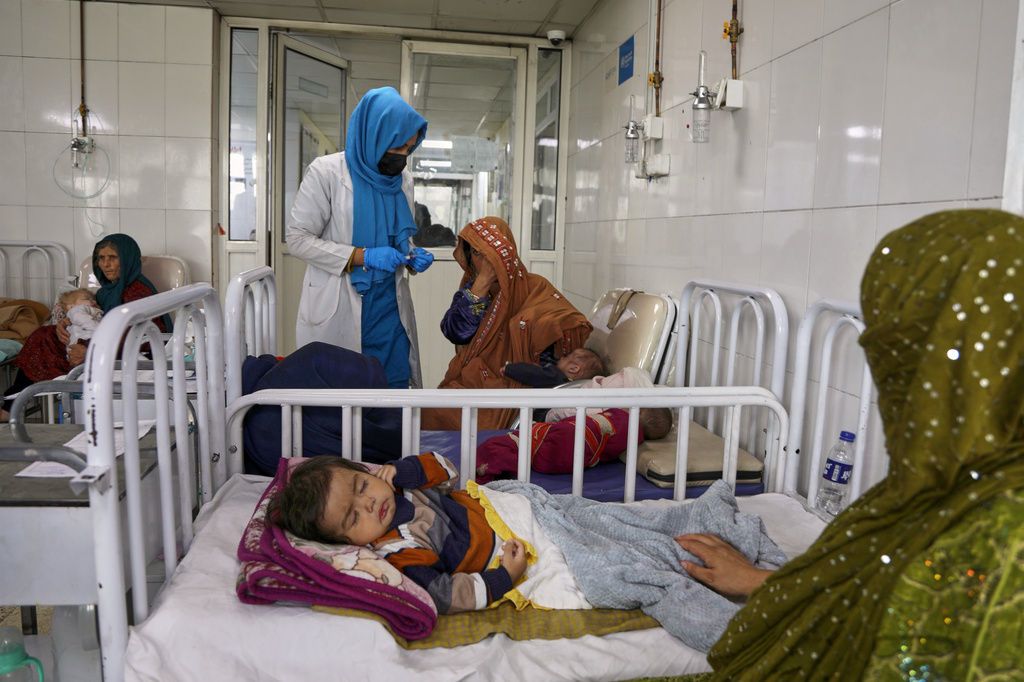 FILE - Afghan women care for their children in the malnutrition ward at Indira Gandhi Children's Hospital in Kabul, Afghanistan, Feb. 15, 2026. (AP Photo/Siddiqullah Alizai, File)
