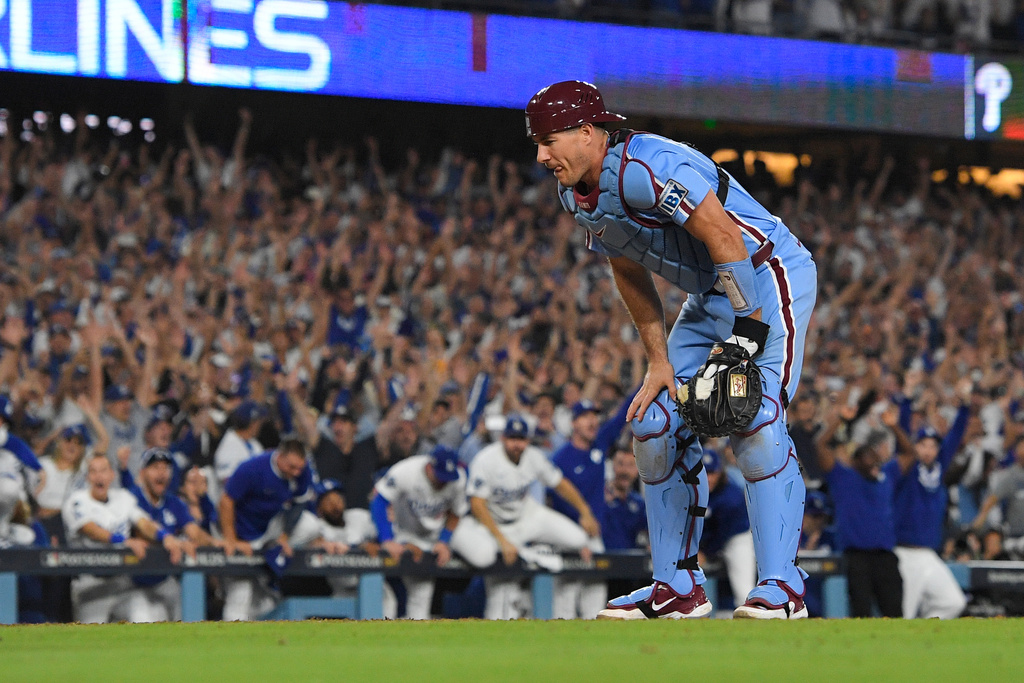 Philadelphia Phillies catcher J.T. Realmuto looks down after Los Angeles Dodgers' Hyeseong Kim scored the game-winning run on a ground ball by Andy Pages and a throwing error by Phillies pitcher Orion Kerkering during the eleventh inning in Game 4 of baseball's National League Division Series Thursday, Oct. 9, 2025, in Los Angeles. (AP Photo/Mark J. Terrill)