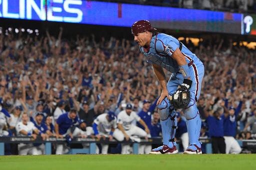 Philadelphia Phillies catcher J.T. Realmuto looks down after Los Angeles Dodgers' Hyeseong Kim scored the game-winning run on a ground ball by Andy Pages and a throwing error by Phillies pitcher Orion Kerkering during the eleventh inning in Game 4 of baseball's National League Division Series Thursday, Oct. 9, 2025, in Los Angeles. (AP Photo/Mark J. Terrill) Philadelphia Phillies catcher J.T. Realmuto looks down after Los Angeles Dodgers' Hyeseong Kim scored the game-winning run on a ground ball by Andy Pages and a throwing error by Phillies pitcher Orion Kerkering during the eleventh inning in Game 4 of baseball's National League Division Series Thursday, Oct. 9, 2025, in Los Angeles. (AP Photo/Mark J. Terrill)