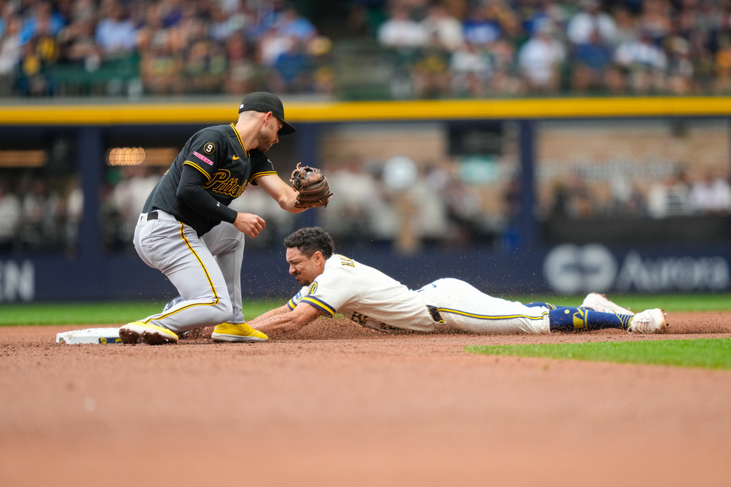 Pittsburgh Pirates second baseman Brandon Lowe, left, is late to the tag as Milwaukee Brewers' David Hamilton, right, steals second base during the third inning of a baseball game Thursday, Aug. 6, 2026, in Milwaukee. (AP Photo/Kayla Wolf)