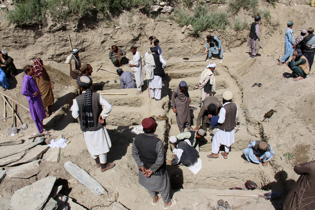 Residents dig graves for victims, including children, of airstrikes that Taliban officials said were carried out by Pakistan, in Mana, a village in Afghanistan's Khost province, Wednesday, June 10, 2026. (AP Photo/Saifullah Zahir)