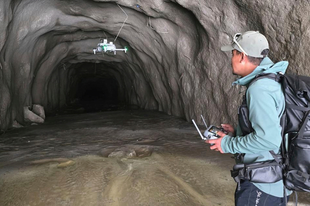 In this image provided by Manish Maharjan, filmmaker and drone pilot Manish Maharjan operates a drone at the entrance to a tunnel at the Rashuwaghadi hydropower project in Rasuwa district, Nepal, Monday, Aug. 31, 2026. (Manish Maharjan via AP)