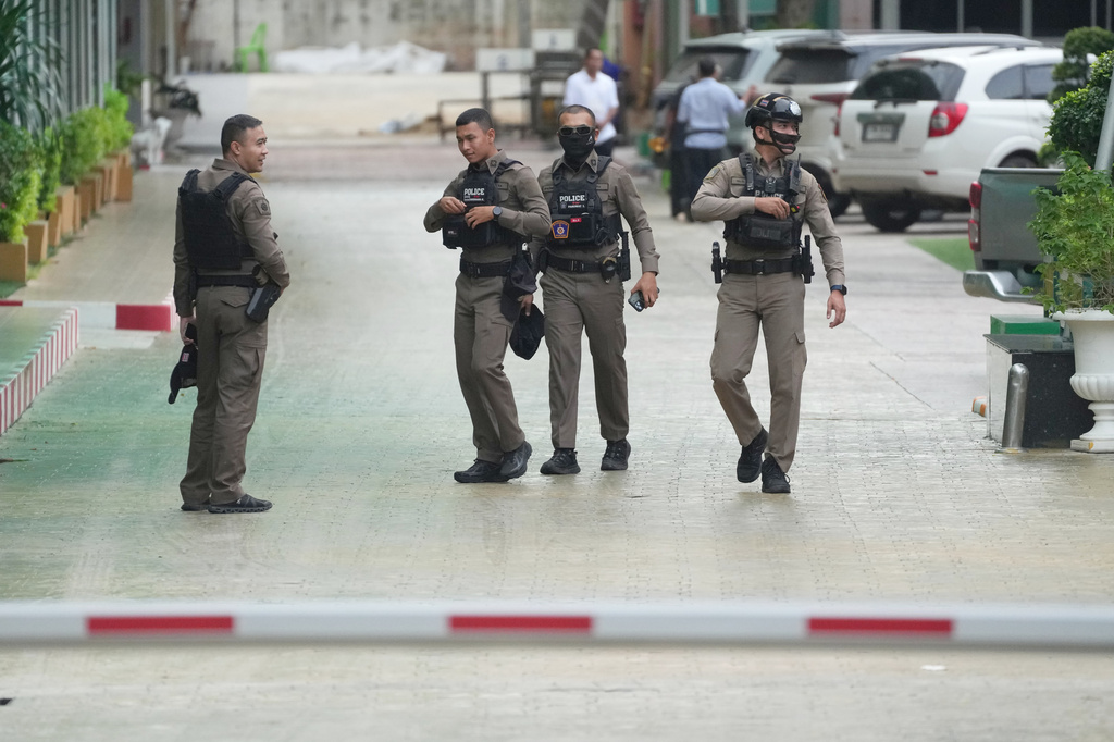 Police officers gather at Debsirin Nonthaburi School, a day after the shooting at the school in Nonthaburi province, Thailand , on Saturday, Aug. 8, 2026. (AP Photo/Sakchai Lalit)