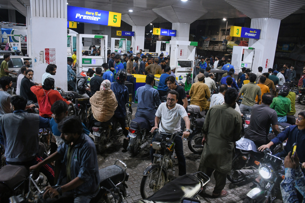 Motorcyclists crowd into a filling station as they wait their turn to buy fuel, in Karachi, Pakistan, Thursday, April 2, 2026. (AP Photo/Ali Raza)