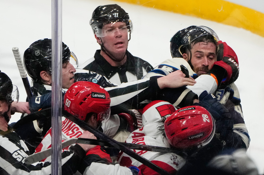 Officials separate Carolina Hurricanes left wing William Carrier (28) and defenseman Erik Gudbranson, right, in the second period of an NHL game in Columbus, Tuesday, March 31, 2026. (AP Photo/Sue Ogrocki)