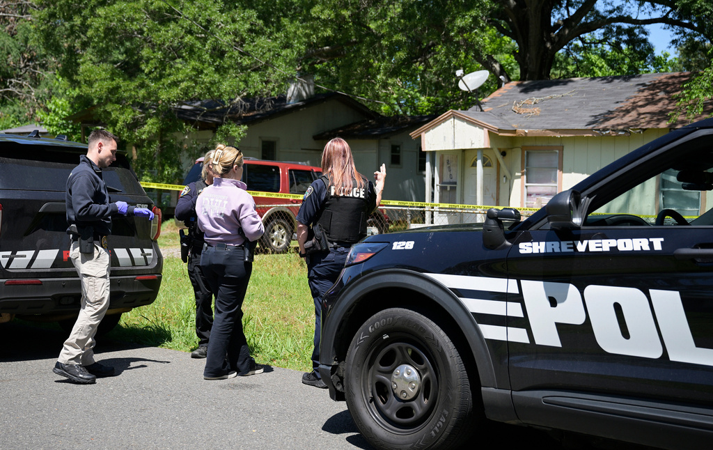 Police gather in front of a house on Harrison Street near Bernstein Avenue, in Shreveport, La., as they investigate a mass shooting, Sunday, April 19, 2026. (Jill Pickett/The Times-Picayune/The New Orleans Advocate via AP)