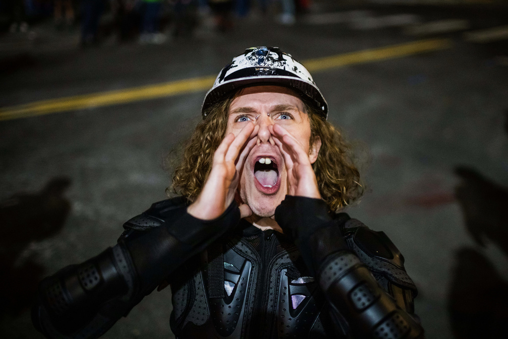 A Portland protester yells during a protest outside a U.S. Immigration and Customs Enforcement facility in Portland, Ore., Monday, Oct. 6, 2025. (AP Photo/Ethan Swope)