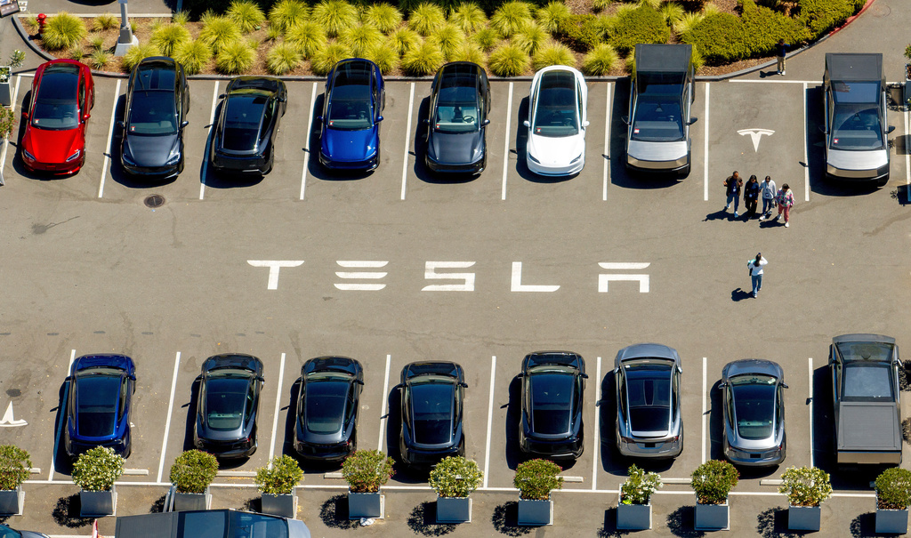 FILE - Tesla vehicles line a parking lot at the company's Fremont, Calif., factory on Aug. 5, 2025. (AP Photo/Noah Berger, File)