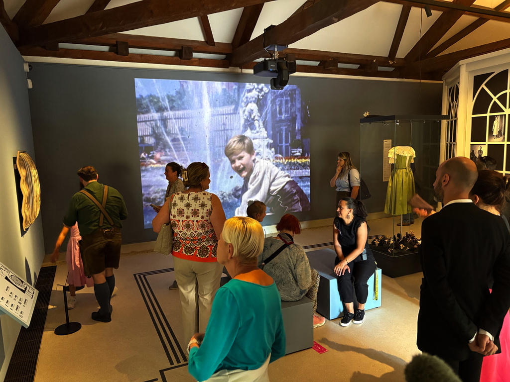 In this photo taken with a smartphone, people gather in the exhibition of the new "Sound Of Music Salzburg" museum in Salzburg, Austria, Sunday, Sept. 20, 2026. (AP Photo/Philipp-Moritz Jenne)