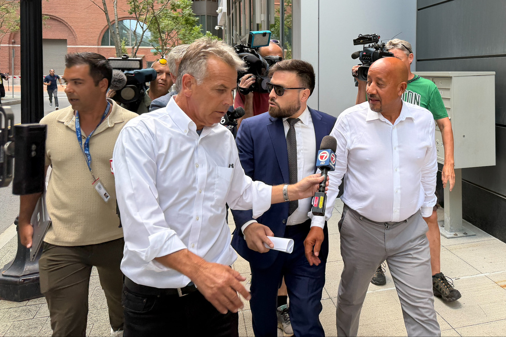 Lawrence, Mass., Mayor Brian DePena, right, leaves federal court in Boston on Friday, Aug. 14, 2026, after making an initial appearance on charges that he fraudulently obtained a pandemic loan and using the money to fund election campaign, pay off high-interest mortgages and back taxes. (AP Photos/Michael Casey)