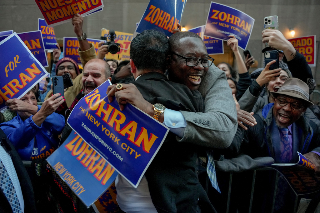 Democratic candidate Zohran Mamdani, left, greets supporters upon arriving to participate in a mayoral debate, Oct. 16, 2025, in New York. (AP Photo/Angelina Katsanis, File)