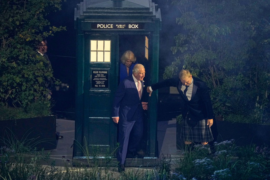 Britain's King Charles III, centre, steps out of the the Dr Who Tardis police box as he arrives at the start of the Commonwealth Games opening ceremony in Glasgow, Scotland, Thursday, July 23, 2026. (AP Photo/Manish Swarup)