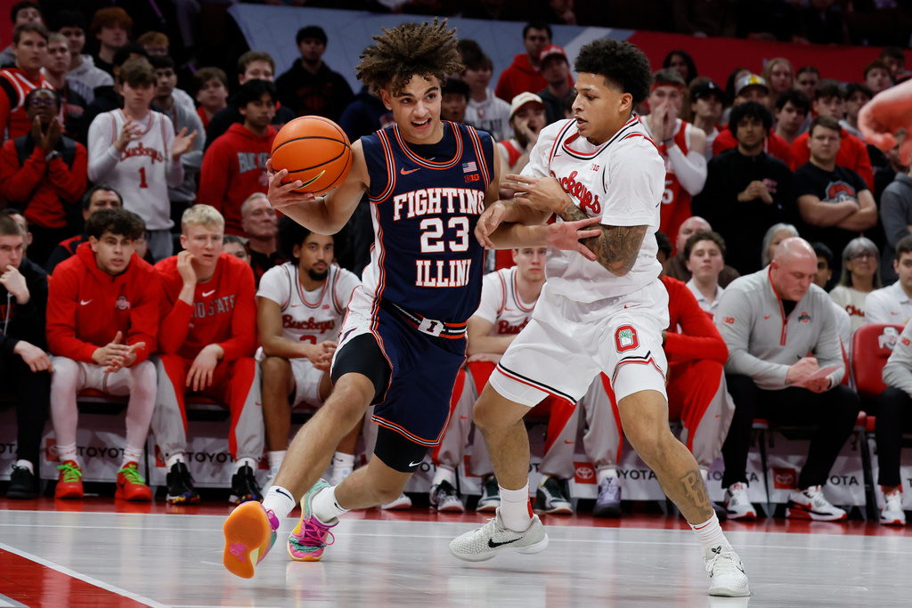 Illinois' Keaton Wagler, left, drives the baseline as Ohio State's John Mobley defends during the first half of an NCAA college basketball game, Tuesday, Dec. 9, 2025, in Columbus, Ohio. (AP Photo/Jay LaPrete)