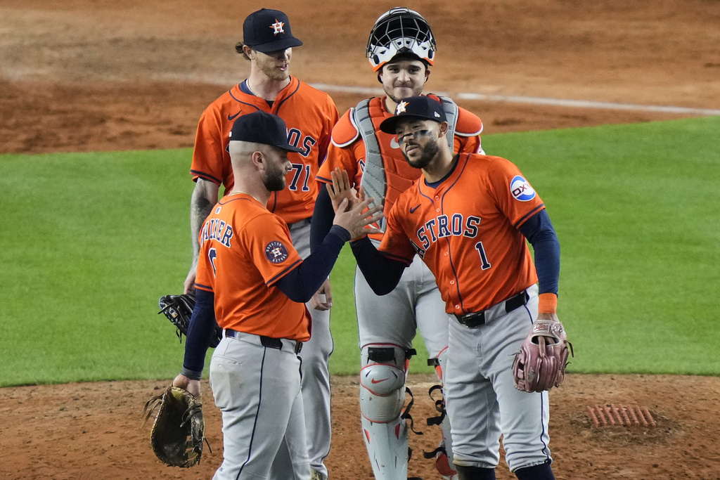 Houston Astros' Carlos Correa (1) celebrates with Christian Walker (8) after a baseball game against the New York Yankees Friday, Aug. 8, 2025, in New York. (AP Photo/Frank Franklin II)