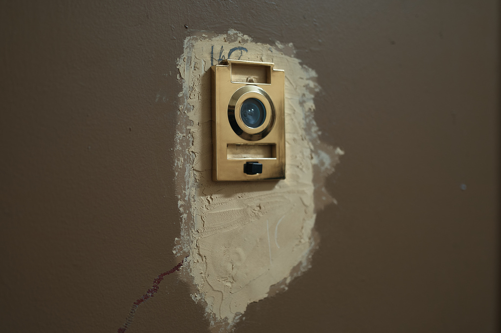 A broken peephole in an apartment building where tenants report maintenance issues and pest infestations, in the Bronx borough of New York, Tuesday, March 17, 2026. (AP Photo/Andres Kudacki)