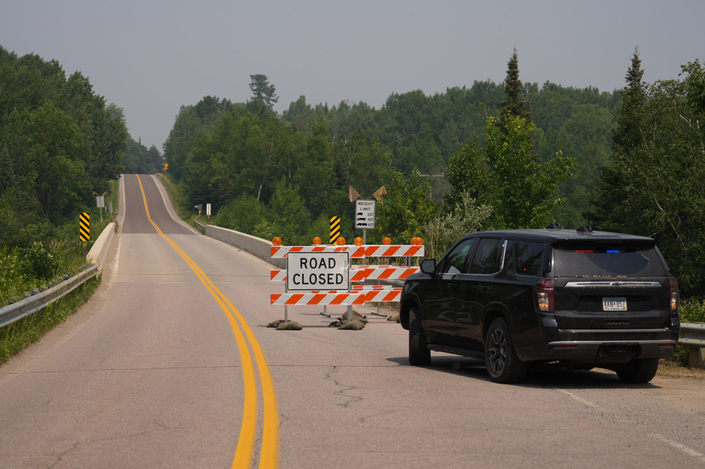 A law enforcement vehicle blocks off a road leading to the Fall Lake entry point, Tuesday, July 14, 2026, near Ely, Minn. (Anthony Soufflé/Minnesota Star Tribune via AP)