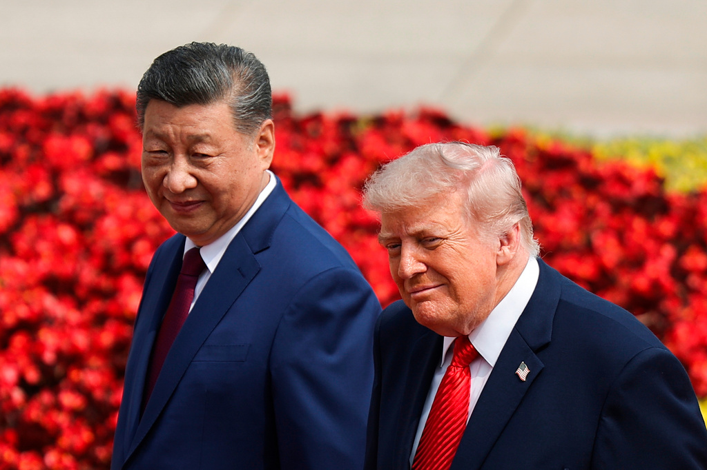 U.S. President Donald Trump, right, and Chinese President Xi Jinping attend a welcome ceremony at the Great Hall of the People in Beijing, Thursday, May 14, 2026. (Maxim Shemetov/Pool Photo via AP)