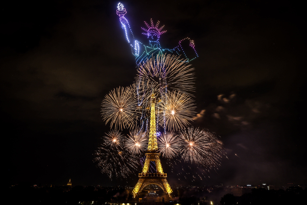Fireworks and drones illuminate the Eiffel Tower in Paris, during the eve of Bastille Day celebrations late Monday, July 13, 2026. (AP Photo/Thomas Padilla)