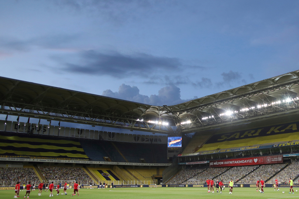 FILE - Fenerbahce and Kayserispor players warm up prior to a Turkish Super League soccer match between Fenerbahce and Kayserispor in Istanbul, Friday, June 12, 2020. (Erdem Sahin/Pool via AP, File)