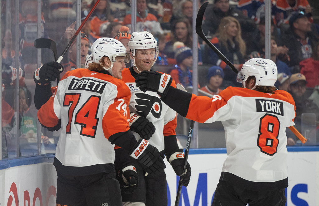 Philadelphia Flyers' Owen Tippett (74), Denver Barkey (52), Sean Couturier (14) and Cam York (8) celebrate a goal against the Edmonton Oilers during the first period of an NHL hockey game, in Edmonton, Saturday, Jan. 3, 2026. (Jason Franson/The Canadian Press via AP)