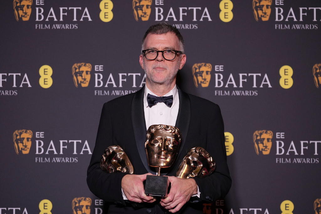 Paul Thomas Anderson poses with the awards for best director, cinematography, and adapted screenplay for 'One Battle After Another' at the 79th British Academy Film Awards, BAFTA's, in London, Sunday, Feb. 22, 2026. (AP Photo/Alastair Grant)