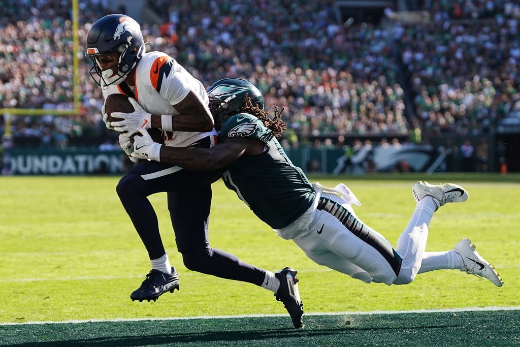 Denver Broncos wide receiver Troy Franklin (11) catches the ball for a two-point conversion in front of Philadelphia Eagles cornerback Kelee Ringo (7) during the second half of an NFL football game Sunday, Oct. 5, 2025, in Philadelphia. (AP Photo/Matt Rourke)