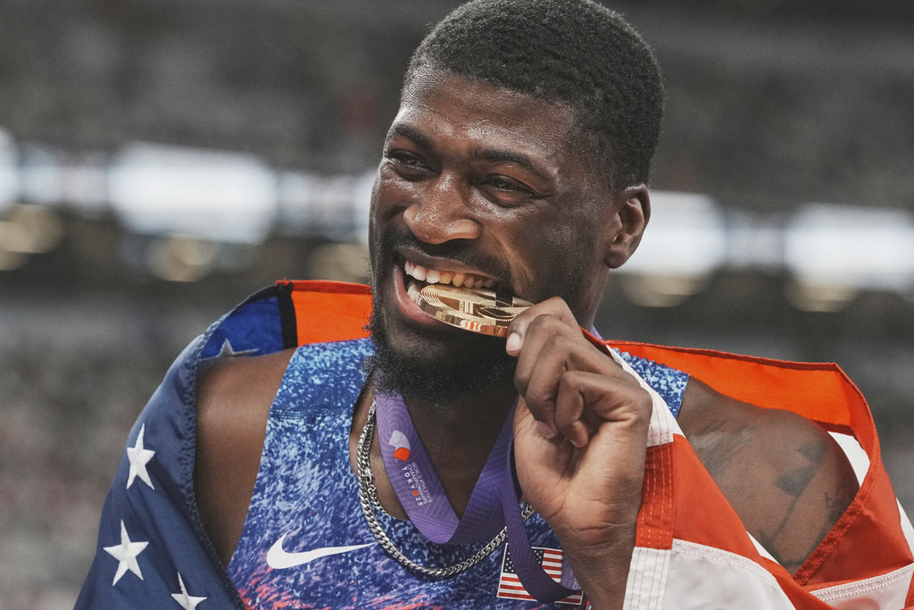 United States' Cordell Tinch celebrates after winning gold medal in men's 110 meters hurdles final at the World Athletics Championships in Tokyo, Tuesday, Sept. 16, 2025. (AP Photo/Eugene Hoshiko)