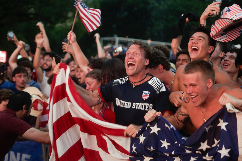 Fans react to the first goal by the United States at a watch party on the National Mall in Washington for a World Cup round of 16 soccer match between the United States and Belgium, Monday, July 6, 2026. (AP Photo/Rod Lamkey, Jr.)