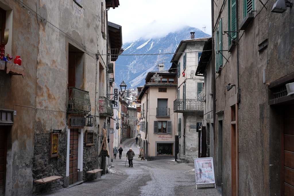 People stroll through Bormio, Italy, during the 2026 Winter Olympics, in Tuesday, Feb. 10, 2026. (AP Photo/Rebecca Blackwell)