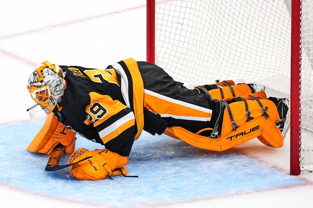 Pittsburgh Penguins goalie Marc-Andre Fleury does pushups in the goal crease between shooters during a shootout following a pre-season NHL hockey game against the Columbus Blue Jackets in Pittsburgh, Saturday, Sept. 27, 2025. (AP Photo/Gene J. Puskar)