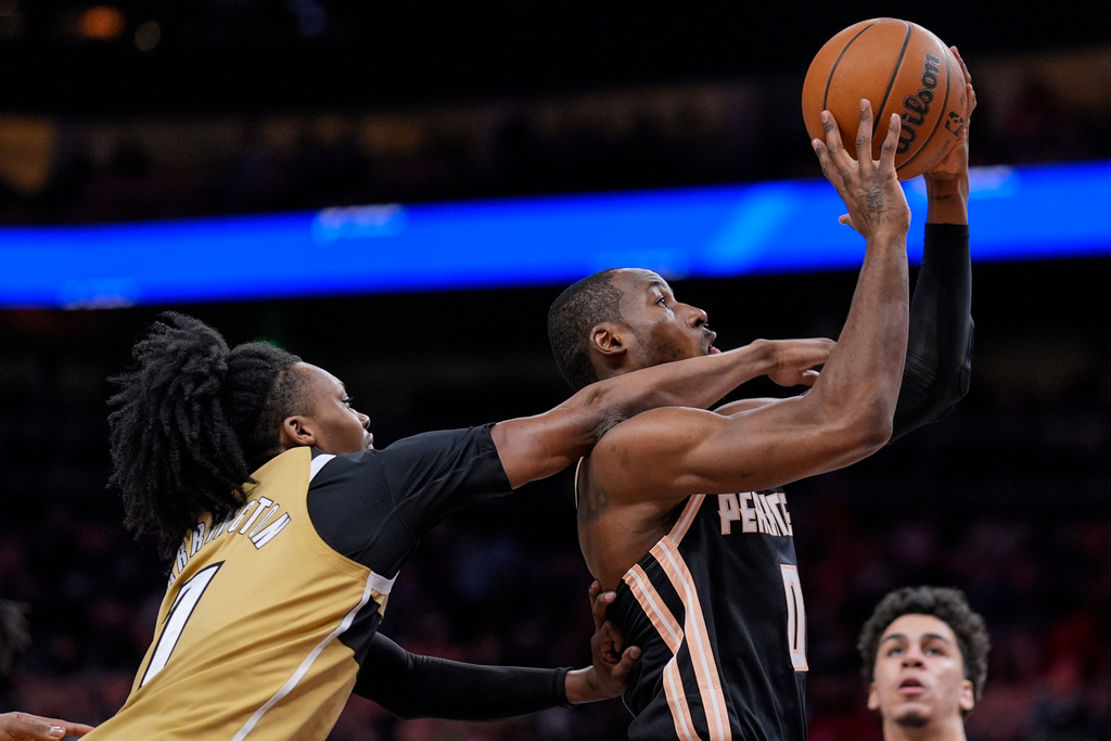 Atlanta Hawks guard Rayj Dennis (0) drives against Washington Wizards guard Bub Carrington (7) during the first half of an NBA basketball game, Thursday, Feb. 26, 2026, in Atlanta. (AP Photo/Mike Stewart)