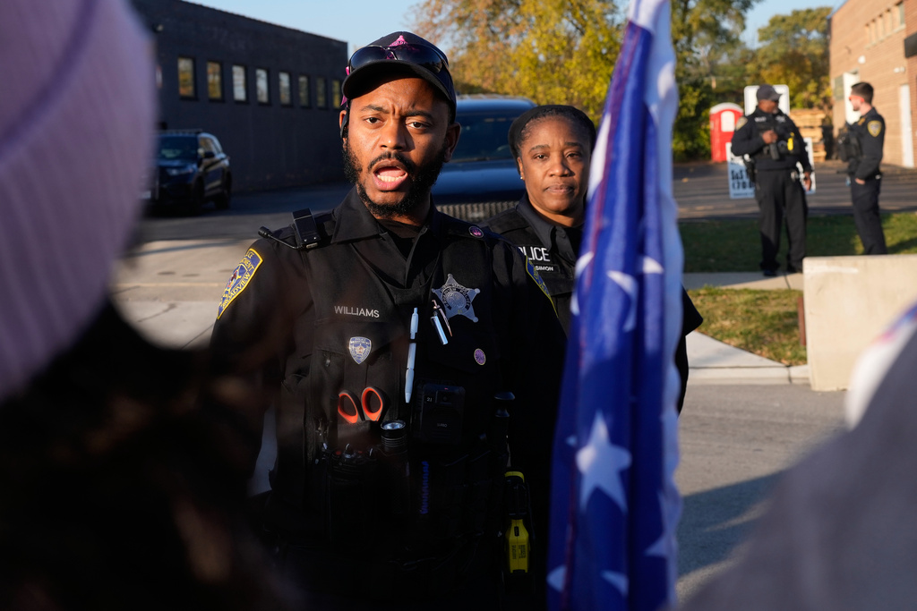 Police guard the designated protest area as protesters gather outside an ICE processing facility in the Chicago suburb of Broadview, Ill., Friday, Oct. 31, 2025. (AP Photo/Nam Y. Huh)